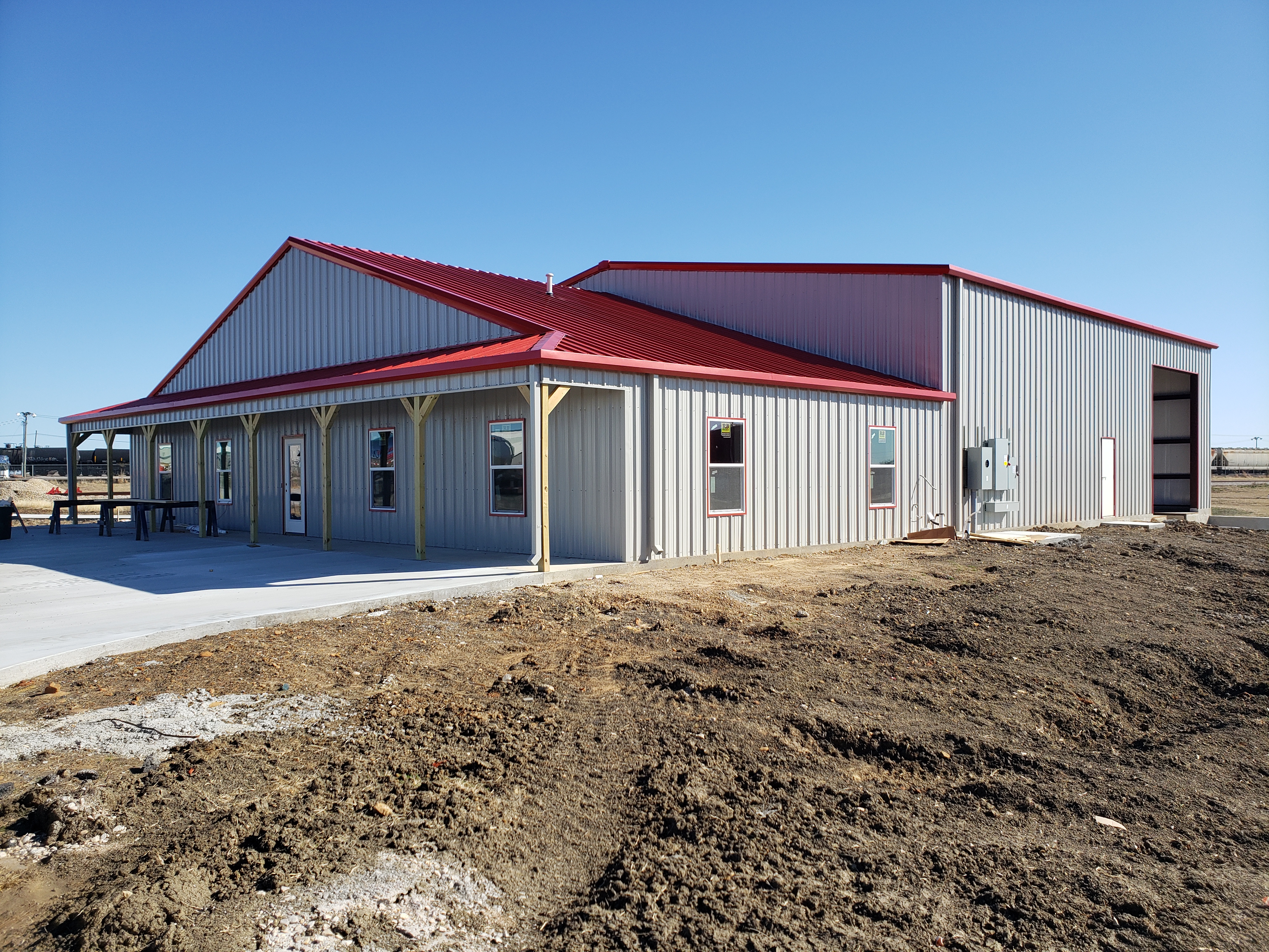 Office with shop building with red roof and covered entry