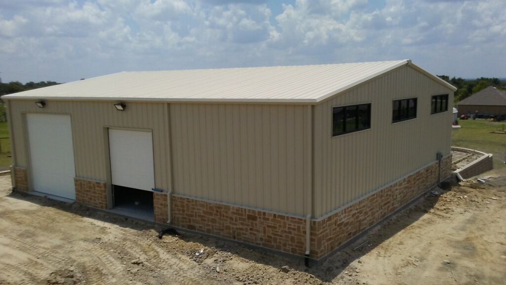 Residential metal shop with stone wainscot in Heath, Texas